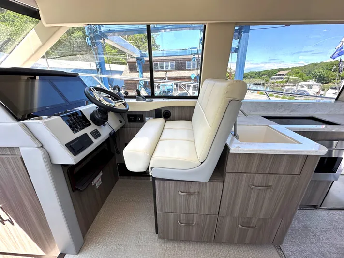  Yacht Photos Pics Interior helm station of 2022 Regal 42 Grande Coupe yacht with modern controls and seating.