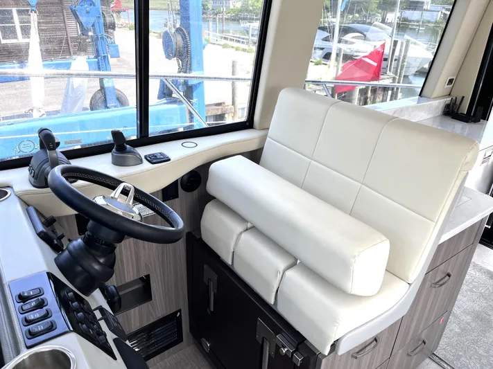  Yacht Photos Pics Captain's seat and helm of 2022 Regal 42 Grande Coupe yacht.