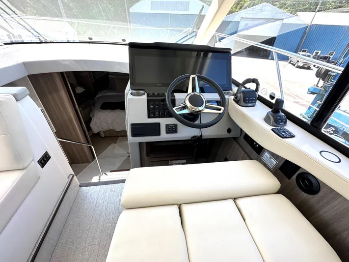  Yacht Photos Pics 2022 Regal 42 Grande Coupe helm station with modern controls and navigation equipment.