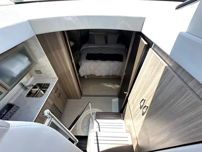  Yacht Photos Pics Interior of 2022 Regal 42 Grande Coupe yacht with modern kitchen and cozy bedroom.