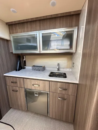  Yacht Photos Pics Modern kitchen area in 2022 Regal 42 Grande Coupe yacht with sleek cabinetry and stainless steel appliances.
