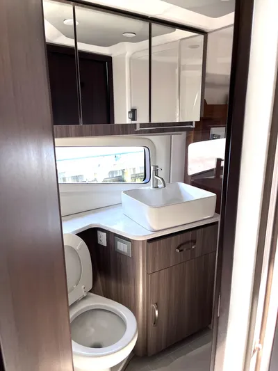  Yacht Photos Pics 2022 Regal 42 Grande Coupe bathroom with modern fixtures and sleek design.