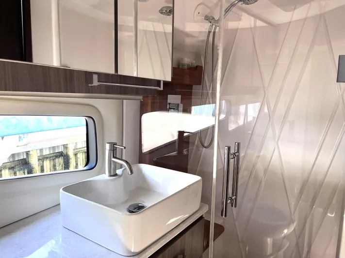  Yacht Photos Pics Modern bathroom in 2022 Regal 42 Grande Coupe yacht with sink and shower.