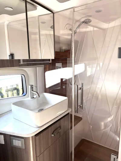  Yacht Photos Pics Modern bathroom in 2022 Regal 42 Grande Coupe yacht with glass shower and vessel sink.