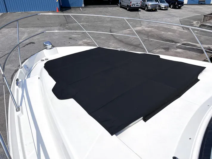  Yacht Photos Pics 2022 Regal 42 Grande Coupe bow with black cover in marina.