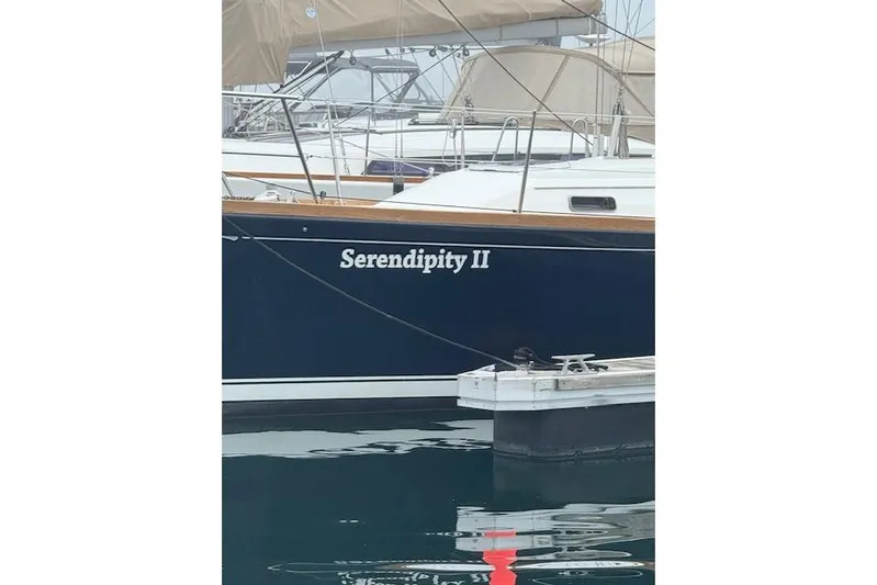 Serendipity II Yacht Photos Pics Sailboat "Serendipity II" docked, Sabre 452 model, 1999, with blue hull and white lettering.