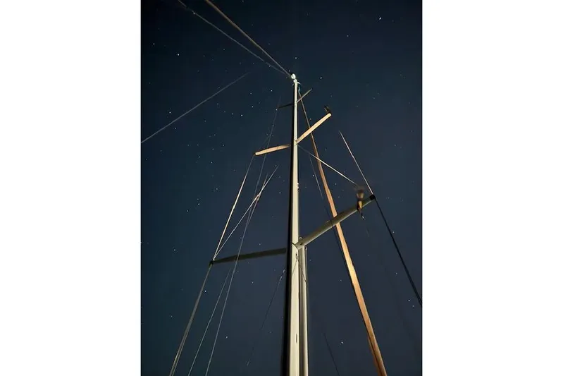 Serendipity II Yacht Photos Pics Mast of 1999 Sabre 452 sailboat against a starry night sky.