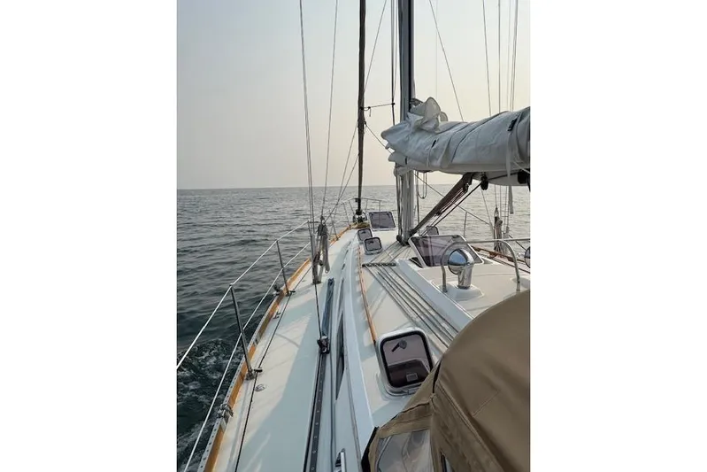 Serendipity II Yacht Photos Pics Sailing on a 1999 Sabre 452 yacht, calm ocean view, clear sky.