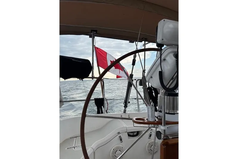 Serendipity II Yacht Photos Pics Sailing on a 1999 Sabre 452 yacht with a Canadian flag in view.