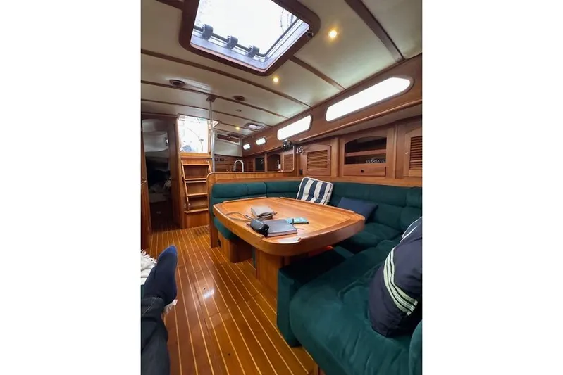 Serendipity II Yacht Photos Pics Luxurious interior of 1999 Sabre 452 yacht with wooden finishes and plush seating.