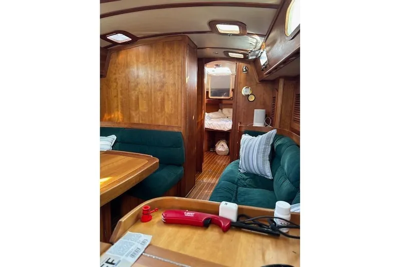 Serendipity II Yacht Photos Pics Interior of 1999 Sabre 452 yacht with wooden finish and green seating.
