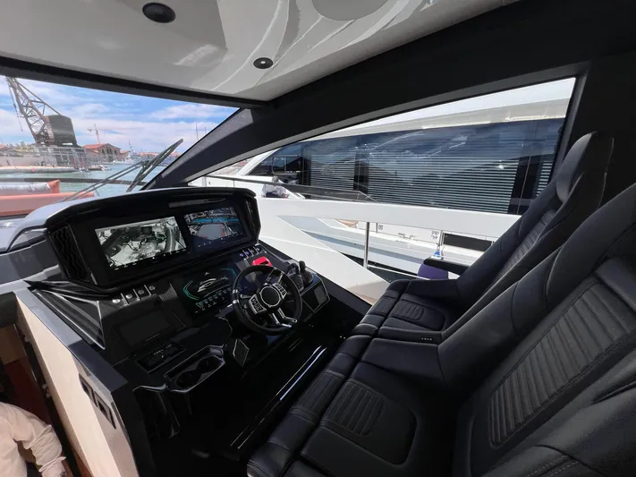  Yacht Photos Pics 2025 Astondoa 677 Coupe yacht cockpit with modern controls and luxurious seating.