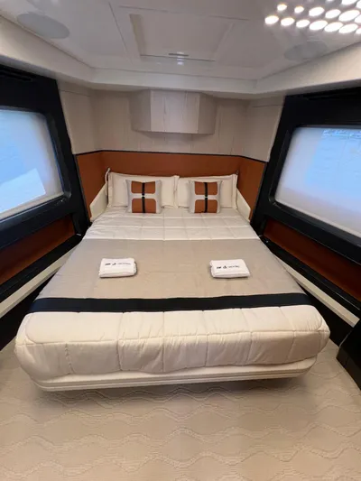  Yacht Photos Pics Luxurious bedroom interior of 2025 Astondoa 677 Coupe yacht with modern design and elegant bedding.