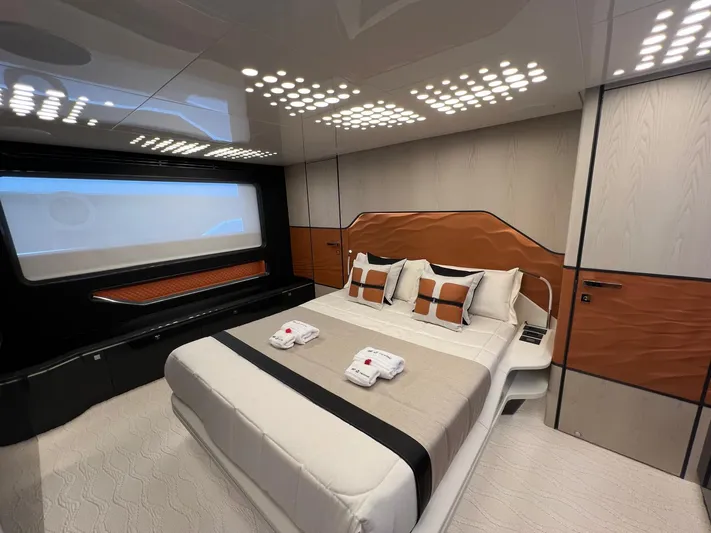  Yacht Photos Pics Luxurious bedroom interior of 2025 Astondoa 677 Coupe yacht with modern design elements.