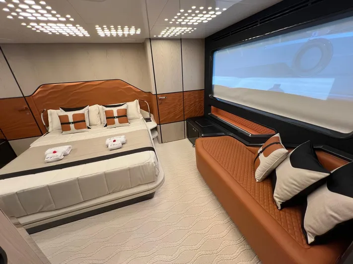  Yacht Photos Pics Luxurious bedroom interior of 2025 Astondoa 677 Coupe yacht with modern design and elegant furnishings.