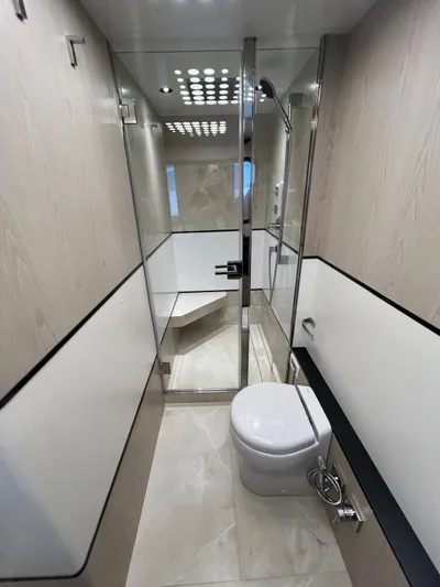  Yacht Photos Pics Luxurious bathroom in 2025 Astondoa 677 Coupe yacht with modern fixtures and sleek design.