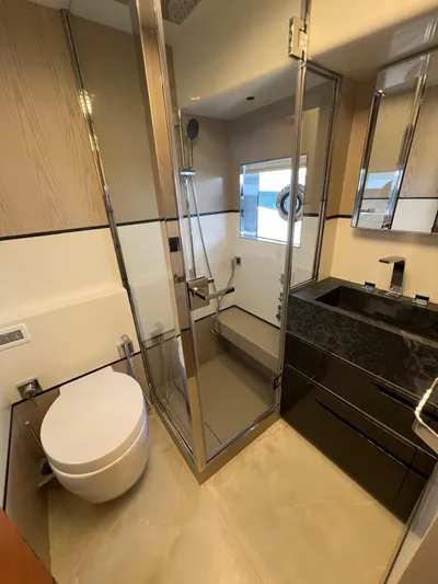  Yacht Photos Pics Luxurious bathroom in 2025 Astondoa 677 Coupe yacht, featuring modern fixtures and elegant design.