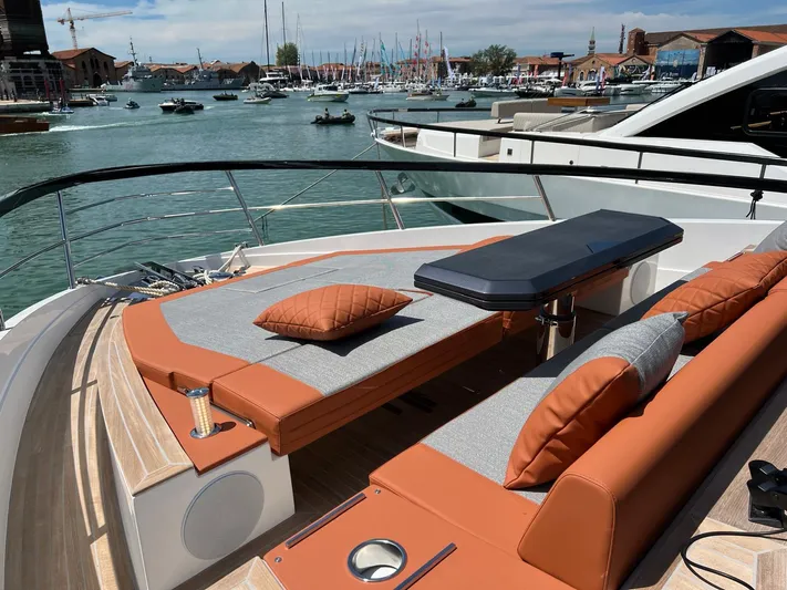  Yacht Photos Pics Luxurious 2025 Astondoa 677 Coupe yacht with elegant deck seating and scenic marina view.