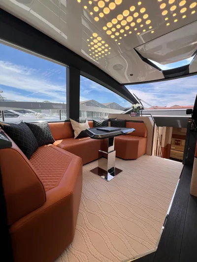  Yacht Photos Pics Luxurious interior of 2025 Astondoa 677 Coupe yacht with modern seating and panoramic views.