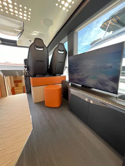  Yacht Photos Pics Luxurious interior of 2025 Astondoa 677 Coupe yacht with modern seating and large TV.