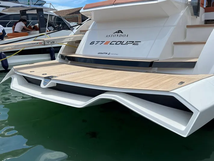  Yacht Photos Pics Astondoa 677 Coupe 2025 yacht stern view with sleek design and wooden deck.