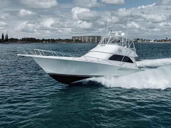 Aegis Yacht Photos Pics 2009 Viking 54 Convertible yacht cruising on open water under a cloudy sky.