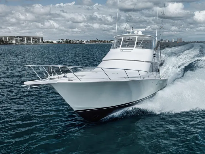 Aegis Yacht Photos Pics 2009 Viking 54 Convertible yacht cruising on open water under cloudy skies.