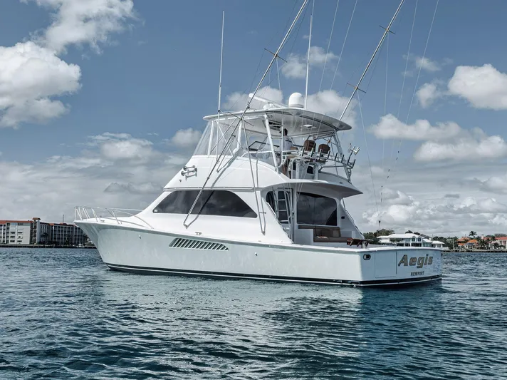 Aegis Yacht Photos Pics 2009 Viking 54 Convertible yacht on calm water under a partly cloudy sky.
