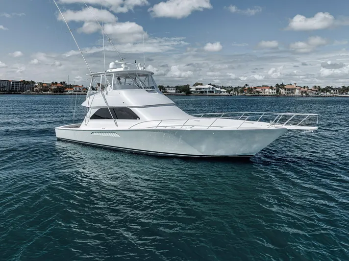 Aegis Yacht Photos Pics 2009 Viking 54 Convertible yacht on calm blue waters under a partly cloudy sky.