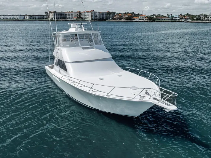 Aegis Yacht Photos Pics 2009 Viking 54 Convertible yacht on calm water, showcasing sleek design and spacious deck.