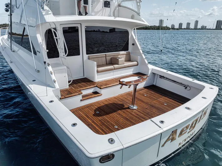 Aegis Yacht Photos Pics 2009 Viking 54 Convertible yacht with spacious deck and seating, cruising on calm waters.