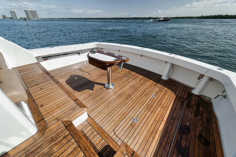 Aegis Yacht Photos Pics 2009 Viking 54 Convertible yacht with teak deck, overlooking calm waters and distant buildings.