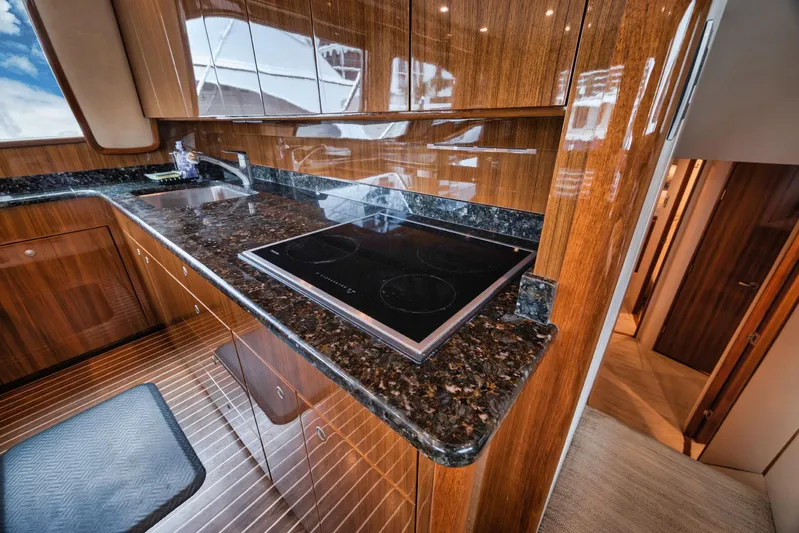 Aegis Yacht Photos Pics Luxurious kitchen interior of 2009 Viking 54 Convertible yacht with sleek countertops.