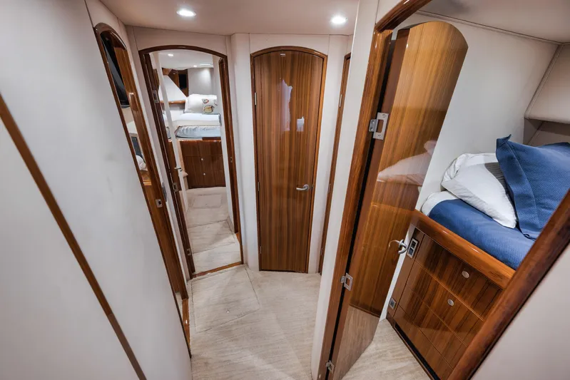 Aegis Yacht Photos Pics Interior of 2009 Viking 54 Convertible yacht with wood finishes and cozy bedrooms.