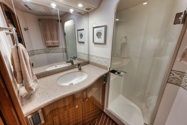 Aegis Yacht Photos Pics Luxurious bathroom in 2009 Viking 54 Convertible yacht with modern fixtures and elegant design.