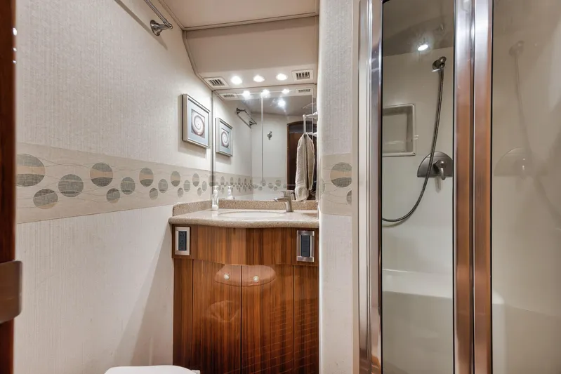 Aegis Yacht Photos Pics Luxurious bathroom in 2009 Viking 54 Convertible yacht with modern fixtures and elegant design.