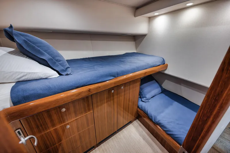 Aegis Yacht Photos Pics 2009 Viking 54 Convertible yacht cabin with wooden cabinetry and blue bedding.