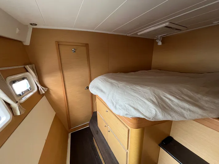 Sunbear Yacht Photos Pics Interior cabin of 2008 Lagoon 420 yacht with bed and window.