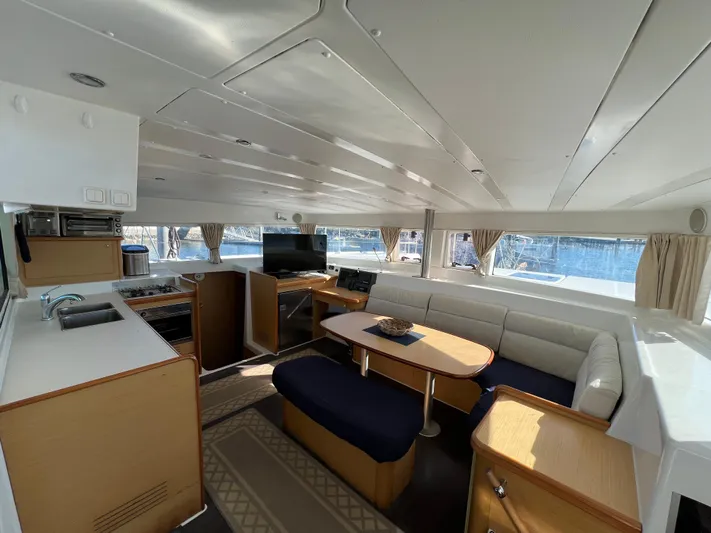 Sunbear Yacht Photos Pics Interior of 2008 Lagoon 420 catamaran with modern kitchen and cozy seating area.