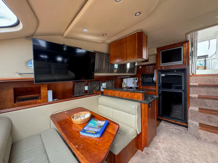 Remote Decktop Yacht Photos Pics Luxurious 2006 Cruisers 415 Express yacht interior with modern kitchen, dining area, and entertainment system.