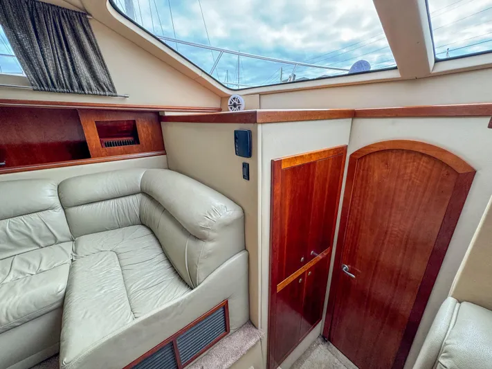 Remote Decktop Yacht Photos Pics Interior of 2006 Cruisers 415 Express yacht with leather seating and wooden cabinetry.