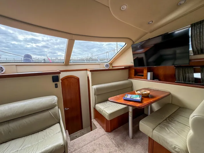 Remote Decktop Yacht Photos Pics Luxurious interior of 2006 Cruisers 415 Express yacht with seating and TV.