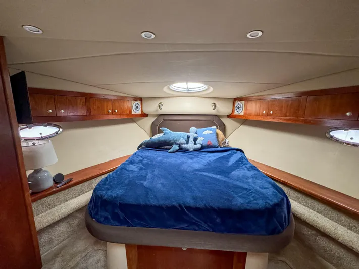Remote Decktop Yacht Photos Pics Luxurious 2006 Cruisers 415 Express yacht cabin with cozy bed and elegant wood cabinetry.