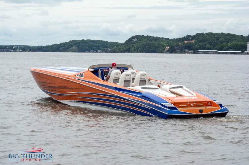  Yacht Photos Pics 2015 Nor-Tech 527 Super Vee speedboat on a lake, orange and blue design.