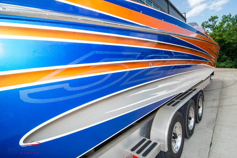  Yacht Photos Pics 2015 Nor-Tech 527 Super Vee boat with vibrant blue and orange design on trailer.