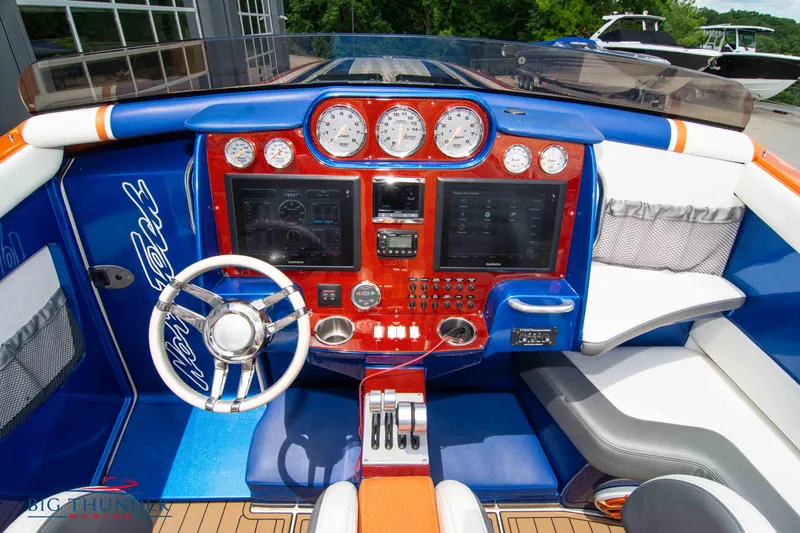  Yacht Photos Pics 2015 Nor-Tech 527 Super Vee boat cockpit with advanced navigation controls and vibrant blue-red interior.