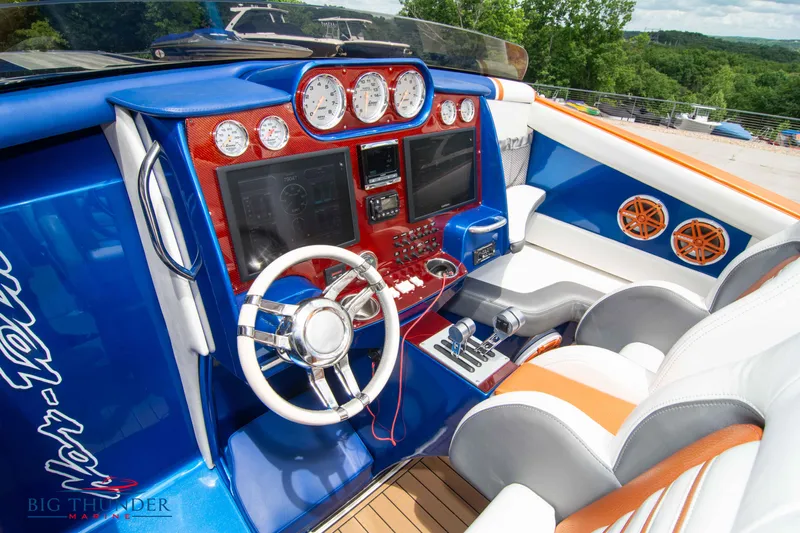  Yacht Photos Pics 2015 Nor-Tech 527 Super Vee boat cockpit with modern controls and vibrant blue and orange interior.