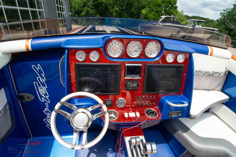  Yacht Photos Pics 2015 Nor-Tech 527 Super Vee boat dashboard with steering wheel and control panels.