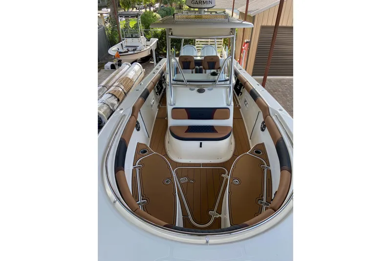  Yacht Photos Pics 2010 Pursuit C 280 Center Console boat with tan and black seating, docked outdoors.