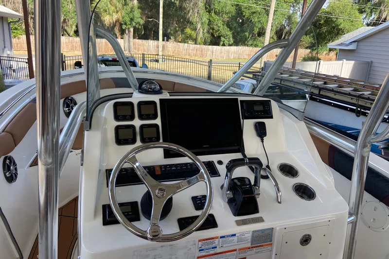  Yacht Photos Pics 2010 Pursuit C 280 Center Console boat dashboard with steering wheel and controls.